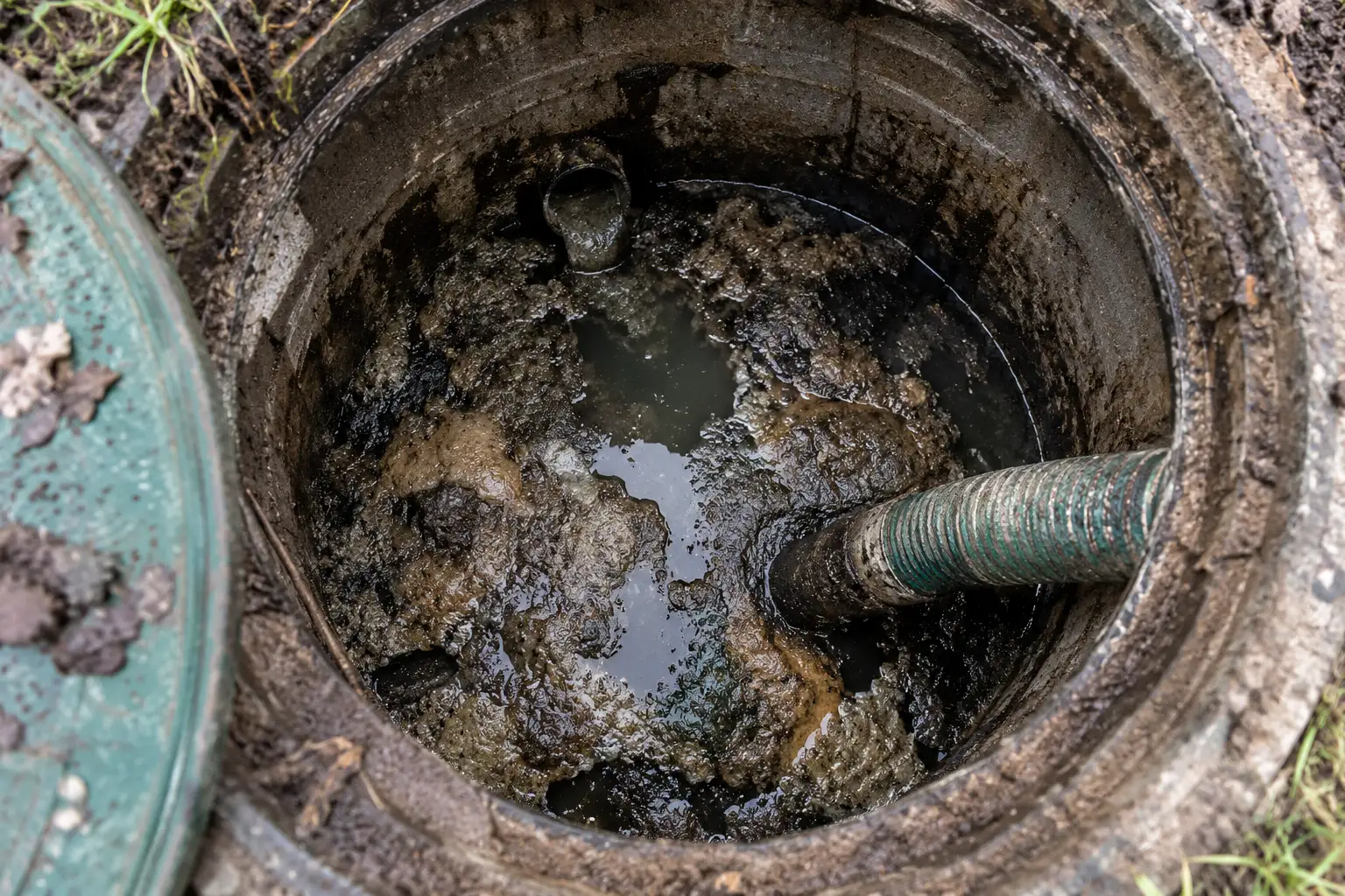 Inside view of a septic tank showing buildup during a cleaning inspection at a rural Ottawa property